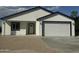 Inviting single story home featuring a two-car garage, gravel landscaping, and modern black trim at 4116 E Park St, Phoenix, AZ 85042
