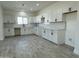Bright kitchen featuring white cabinets, sleek black hardware, subway tile backsplash, and tile flooring at 4116 E Park St, Phoenix, AZ 85042