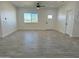 Spacious living room with tile floors, recessed lighting, ceiling fan and view to the outside at 4116 E Park St, Phoenix, AZ 85042