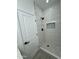 Stylish shower with hexagon tile floor, large white tile walls and black hardware at 4116 E Park St, Phoenix, AZ 85042