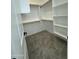 Spacious walk-in closet with custom shelving and hanging rods for optimal organization and storage at 4116 E Park St, Phoenix, AZ 85042