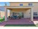 Inviting covered patio with lounge seating and view of artificial grass and outdoor grill at 4138 N 298Th Ln, Buckeye, AZ 85396