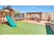Spacious backyard featuring playground, trampoline, and custom outdoor kitchen at 4138 N 298Th Ln, Buckeye, AZ 85396