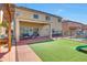 Large backyard with covered patio, artificial grass, and pool at 4138 N 298Th Ln, Buckeye, AZ 85396
