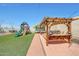 Beautiful backyard featuring outdoor kitchen, playground, trampoline, and low maintenance turf at 4138 N 298Th Ln, Buckeye, AZ 85396