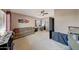 Spacious bedroom featuring a sofa, desk, dark interior doors, and carpeted flooring at 4138 N 298Th Ln, Buckeye, AZ 85396