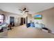 Large bedroom featuring a ceiling fan, workstation, mounted TV and dark-colored doors at 4138 N 298Th Ln, Buckeye, AZ 85396