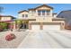 Spacious two-story home featuring a three-car garage, desert landscaping, and a well-maintained lawn at 4138 N 298Th Ln, Buckeye, AZ 85396