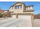 Elegant two-story home with desert landscaping, a three-car garage, and a welcoming facade at 4138 N 298Th Ln, Buckeye, AZ 85396