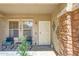 Charming front porch with seating, decorative accents, and a stylish door enhancing curb appeal at 4138 N 298Th Ln, Buckeye, AZ 85396