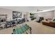 Spacious game room featuring carpeted floors, a foosball table, multiple screens, and gaming stations at 4138 N 298Th Ln, Buckeye, AZ 85396