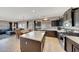 Open-concept kitchen with island, stainless steel appliances, and seamless flow to the dining and living areas at 4138 N 298Th Ln, Buckeye, AZ 85396