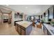 Large kitchen with island, stainless steel appliances, and a clear view of the dining and living areas at 4138 N 298Th Ln, Buckeye, AZ 85396