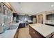 Well-lit kitchen featuring a central island, stainless steel appliances, and ample countertop space at 4138 N 298Th Ln, Buckeye, AZ 85396