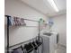Laundry room showcasing a washer and dryer, shelving, and storage for laundry supplies at 4138 N 298Th Ln, Buckeye, AZ 85396