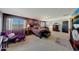 A spacious main bedroom with a large bed, two bedside tables, and a seating area at 4138 N 298Th Ln, Buckeye, AZ 85396