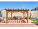 Backyard with outdoor kitchen, custom pergola, bbq area and gas grill at 4138 N 298Th Ln, Buckeye, AZ 85396