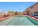 A clean private pool is surrounded by patio furniture, a playset, and mature landscaping at 4138 N 298Th Ln, Buckeye, AZ 85396