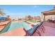 Backyard with pool, lounge chairs, covered patio, playground, and artificial grass at 4138 N 298Th Ln, Buckeye, AZ 85396
