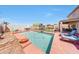 A backyard view of a private pool featuring lounge seating and a playground at 4138 N 298Th Ln, Buckeye, AZ 85396