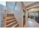 Well-lit staircase with wooden steps leading to the upper level of the home at 4138 N 298Th Ln, Buckeye, AZ 85396