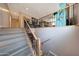 Staircase featuring wood steps and ornate iron railings, leading to a bright, inviting upper level of the home at 4138 N 298Th Ln, Buckeye, AZ 85396