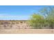 Desert landscaping with block wall and railing at 4138 N 298Th Ln, Buckeye, AZ 85396