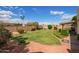 Expansive backyard featuring a lush lawn, mature landscaping, and a charming bird bath at 4232 W Purdue Ave, Phoenix, AZ 85051
