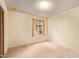 Cozy bedroom with neutral carpet, natural light from window, and a spacious closet for ample storage at 4232 W Purdue Ave, Phoenix, AZ 85051