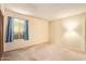 Neutral bedroom with a window, plush carpet, and closet space at 4232 W Purdue Ave, Phoenix, AZ 85051