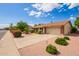A well-manicured lawn and desert landscaping surround this single-Gathering home with a two-car garage at 4232 W Purdue Ave, Phoenix, AZ 85051