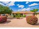 Charming home featuring manicured landscaping, flowering bushes, and a well-maintained two-car garage at 4232 W Purdue Ave, Phoenix, AZ 85051