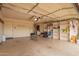 Spacious garage featuring ample storage shelving, overhead door, and convenient side door at 4232 W Purdue Ave, Phoenix, AZ 85051