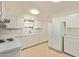 Well-lit kitchen with white cabinetry, appliances, and ample counter space at 4232 W Purdue Ave, Phoenix, AZ 85051