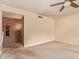 A bright living room with carpet, brick fireplace, and neutral walls providing a comfortable atmosphere at 4232 W Purdue Ave, Phoenix, AZ 85051