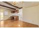 Bright living room with wood floors, beams, and a view to the kitchen at 4232 W Purdue Ave, Phoenix, AZ 85051