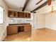 Bright living room with wood floors, beams, and a pass-through to the kitchen at 4232 W Purdue Ave, Phoenix, AZ 85051