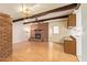 Spacious living room featuring a brick fireplace and wood-look floors at 4232 W Purdue Ave, Phoenix, AZ 85051