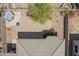 Overhead shot of backyard featuring desert landscaping, a fire pit, covered patio, and a gray tiled roof at 43828 W Roth Rd, Maricopa, AZ 85138