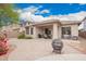 Large backyard with desert landscaping, a covered patio, ample seating, and a fire pit for outdoor enjoyment at 43828 W Roth Rd, Maricopa, AZ 85138
