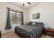 Bedroom featuring a ceiling fan and a window with blinds and curtains at 43828 W Roth Rd, Maricopa, AZ 85138