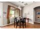Casual dining area with a square table, seating for four, and natural light from the window at 43828 W Roth Rd, Maricopa, AZ 85138