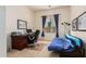 Comfortable home office area with a futon and a large wooden desk at 43828 W Roth Rd, Maricopa, AZ 85138