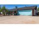 Single story home featuring covered porch with front seating and a light blue garage door at 4402 N 79Th Dr, Phoenix, AZ 85033