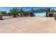 Charming single-story home featuring a light blue garage door and a wide driveway at 4402 N 79Th Dr, Phoenix, AZ 85033