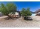 Cozy single-story home with desert landscaping, featuring trees and a gravel yard at 4402 N 79Th Dr, Phoenix, AZ 85033