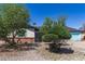 Cozy single-story home with desert landscaping, featuring trees and a gravel yard at 4402 N 79Th Dr, Phoenix, AZ 85033