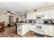 View of Kitchen with oven, microwave, tile flooring and pass through to dining area at 4402 N 79Th Dr, Phoenix, AZ 85033