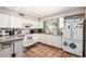 Well-lit kitchen featuring white cabinets, matching appliances, and neutral countertops at 4402 N 79Th Dr, Phoenix, AZ 85033