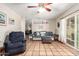 Spacious living room with tile flooring, a ceiling fan, and sliding glass doors at 4402 N 79Th Dr, Phoenix, AZ 85033